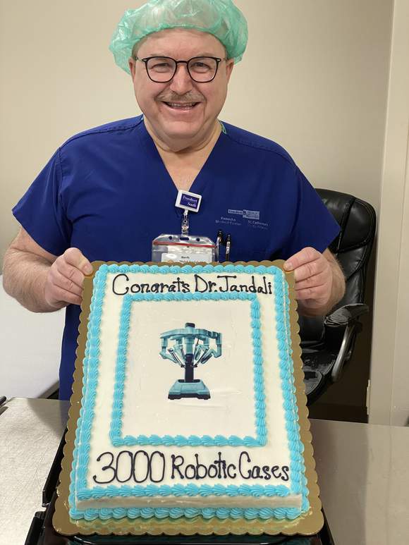 Dr. Jandali holding his cake