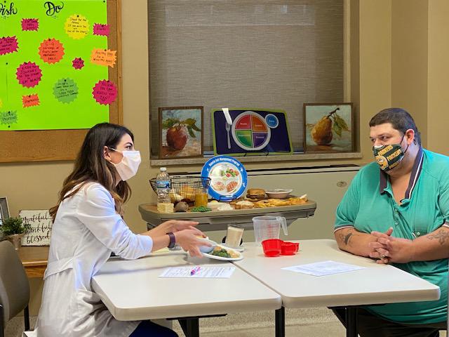 Nutrition Services member with a patient.