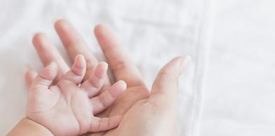 Baby and mother hand